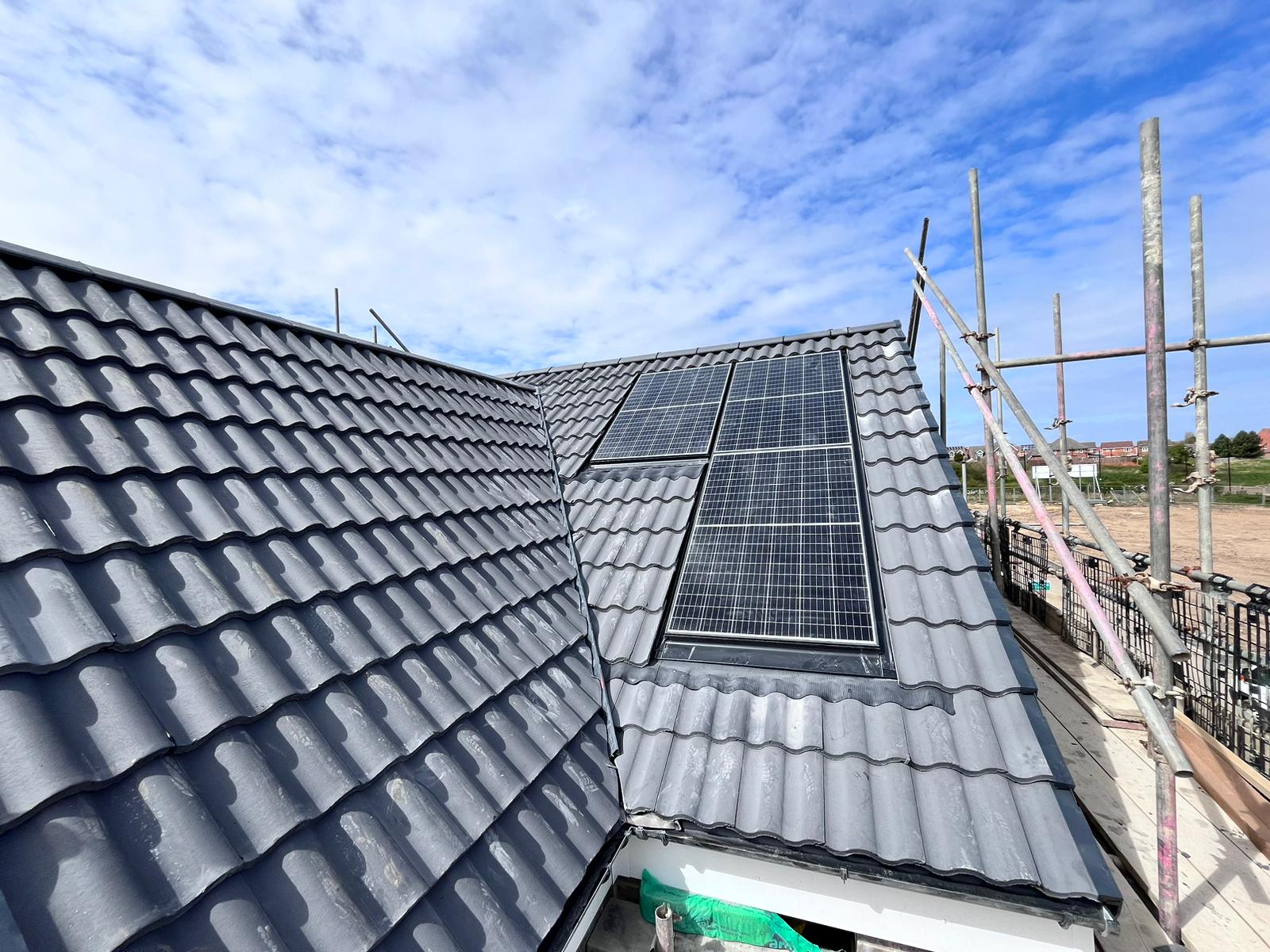 GKRC solar panels on a house roof with scaffolding erected