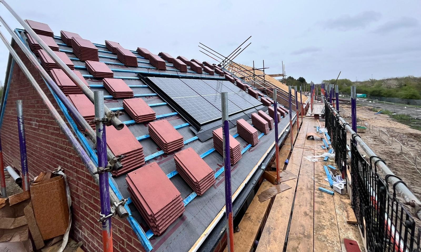 GKRC tiles on a roof ready to be put in place and solar panels installed