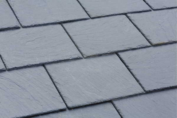 3 tiles on a roof ready to be put in place and solar panels installed